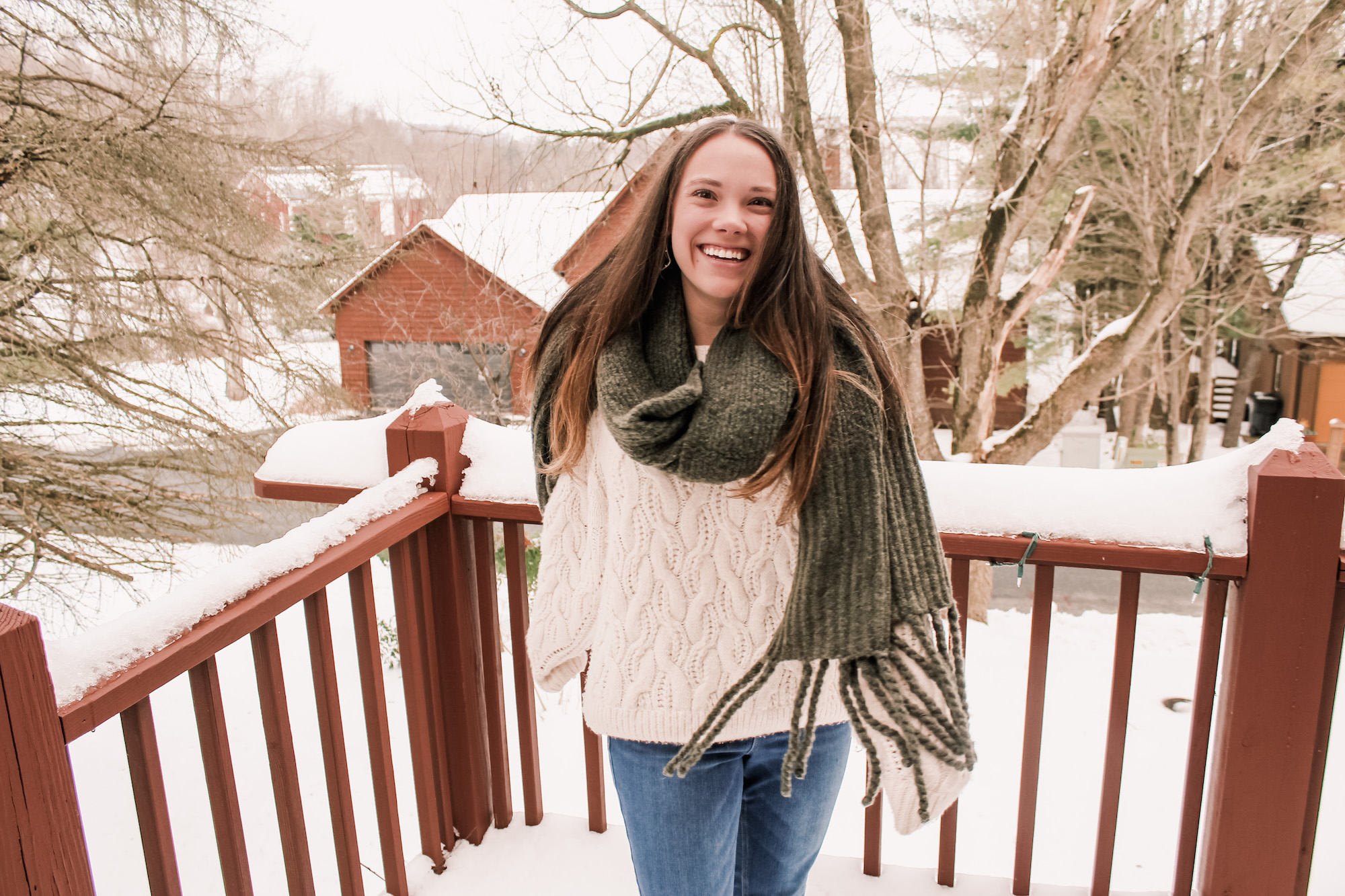 girl smiling in snow and scarf self-love